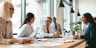 Business meeting with an individual laughing